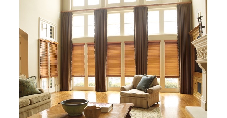 New York great room with natural wood blinds and floor to ceiling drapes.